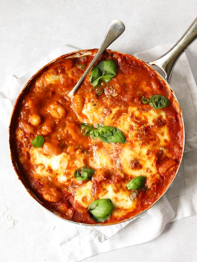 Pan of healthy baked gnocchi in tomato sauce topped with cheese