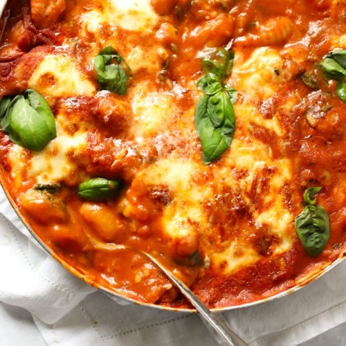 Pan of healthy baked gnocchi in tomato sauce topped with cheese