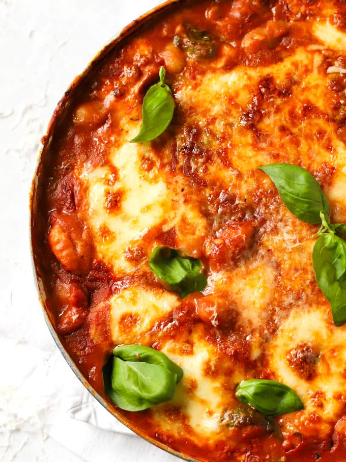 Easy baked gnocchi with a tomato, basil and spinach sauce topped with mozzarella cheese