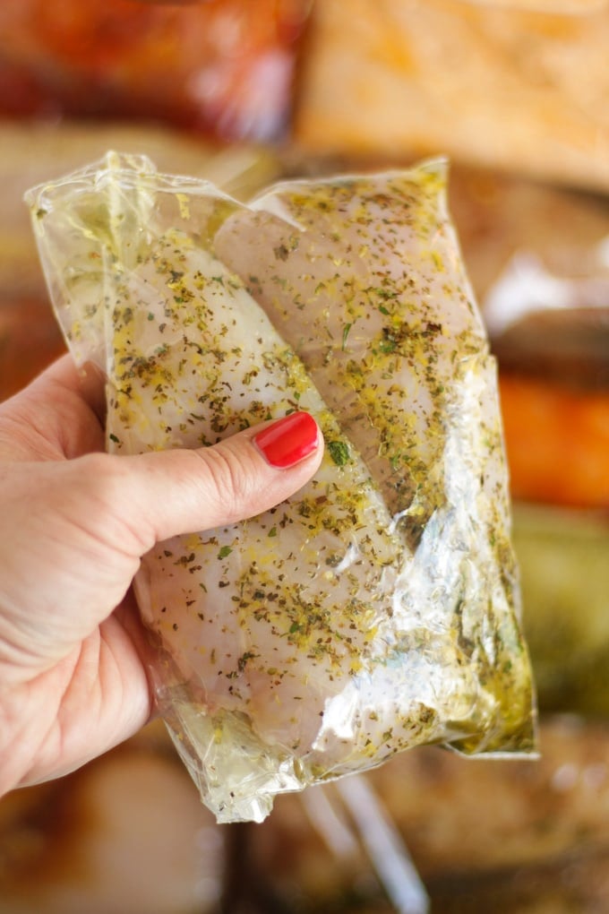 hand holding bag of lemon and herb marinating meat