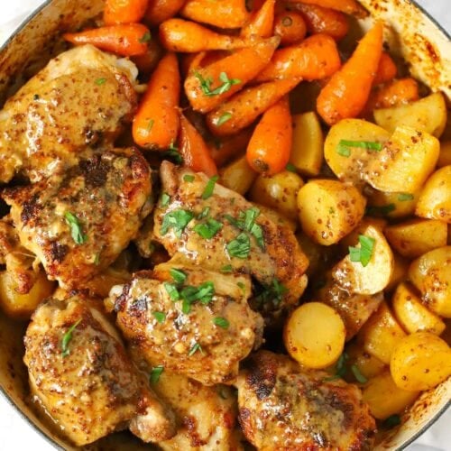 Honey mustard chicken recipe with potatoes and carrots in a round pan.