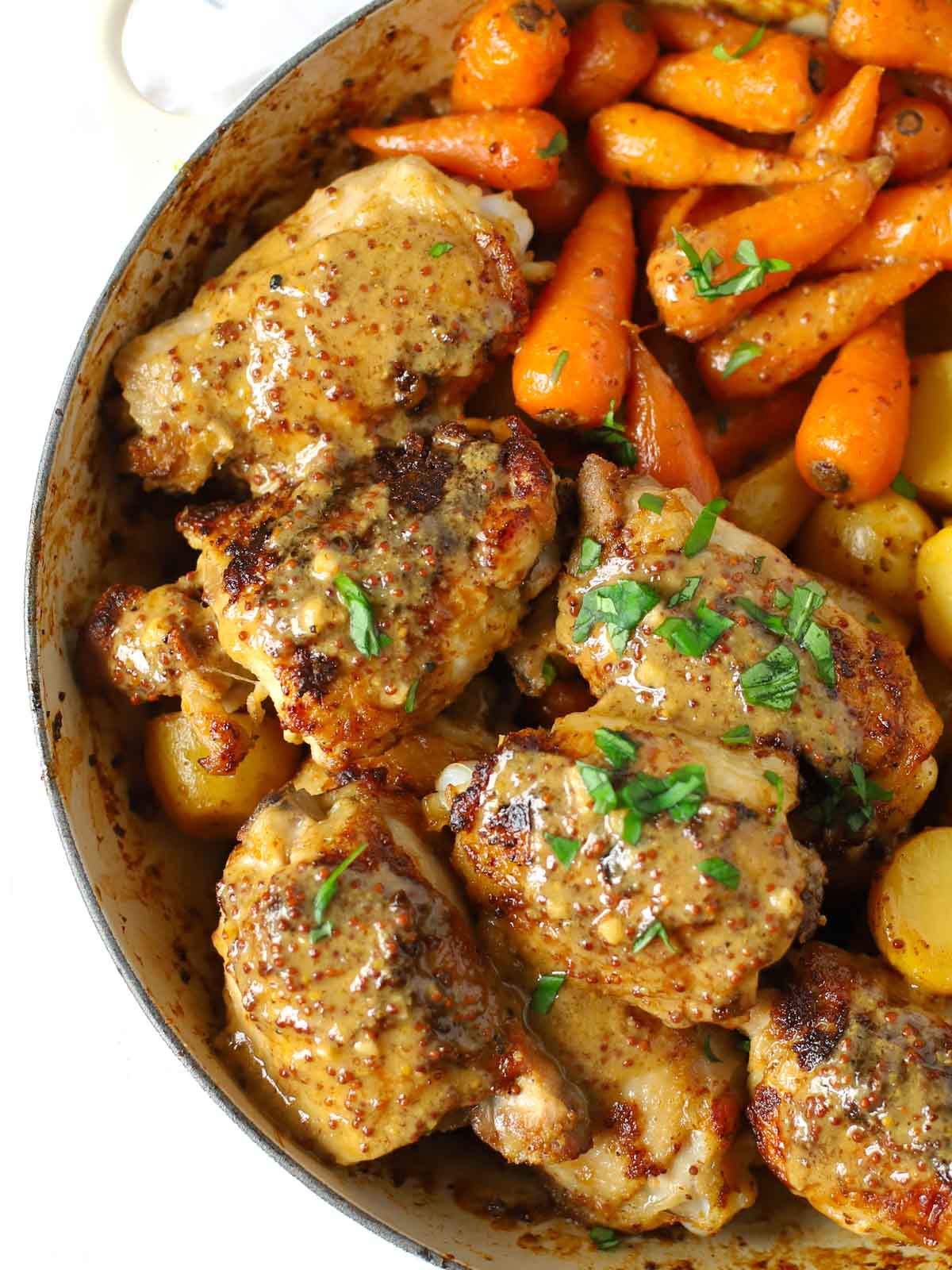 Crunchy roasted chicken thighs with roasted carrots and potatoes in honey mustard sauce.