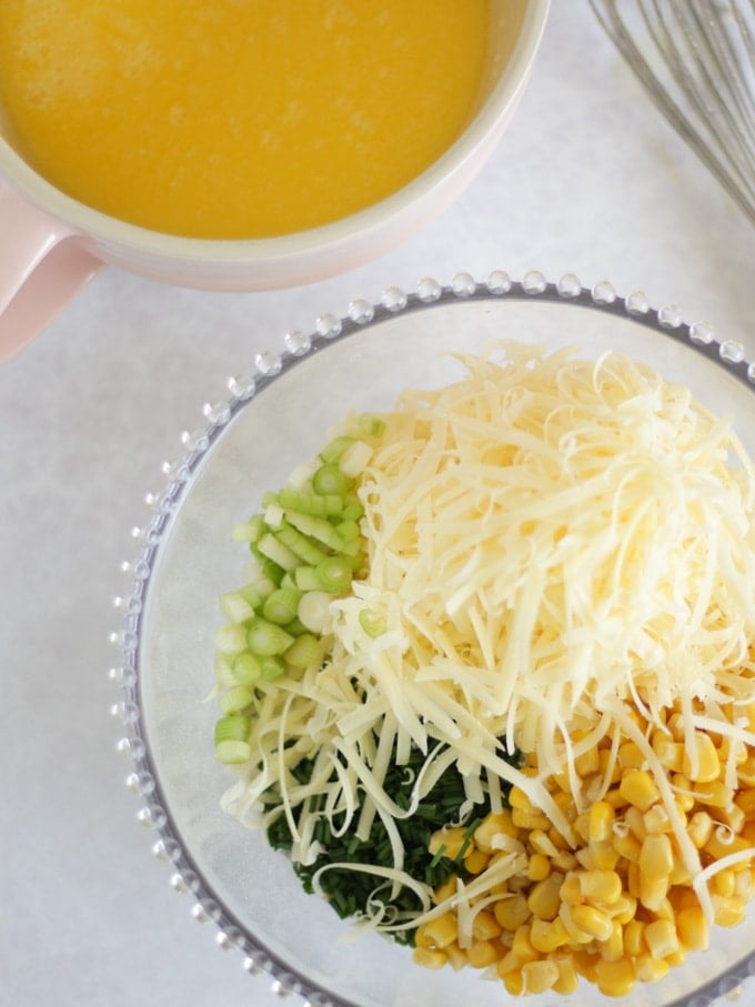 grated cheese, sweetcorn and chives in a bowl