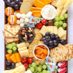 Cheese platter board for kids with child friendly snacks and fruit