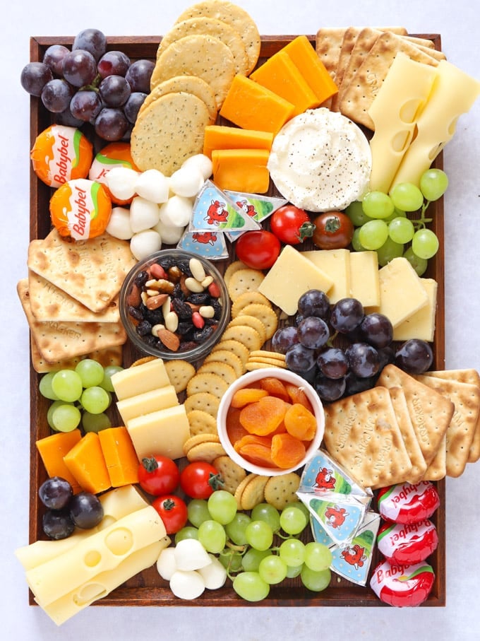 Cheese platter board for kids with child friendly snacks and fruit
