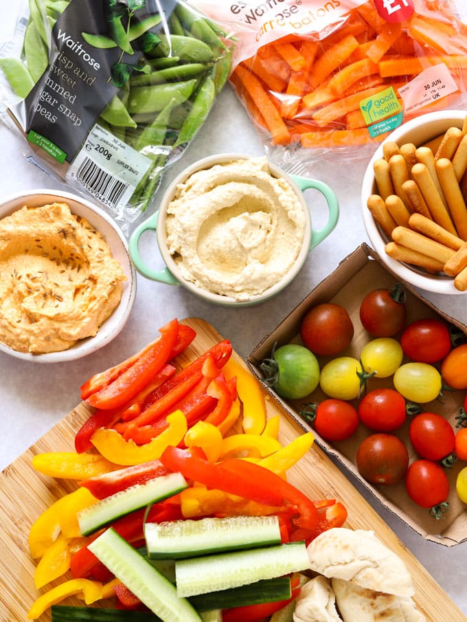 houmous and crudités including tomatoes, sugar snap peas and peppers