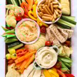 Hummus platter with dips and vegetables, including cucumber and peppers for kids