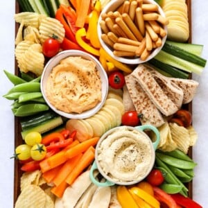 Hummus platter with dips and vegetables, including cucumber and peppers for kids