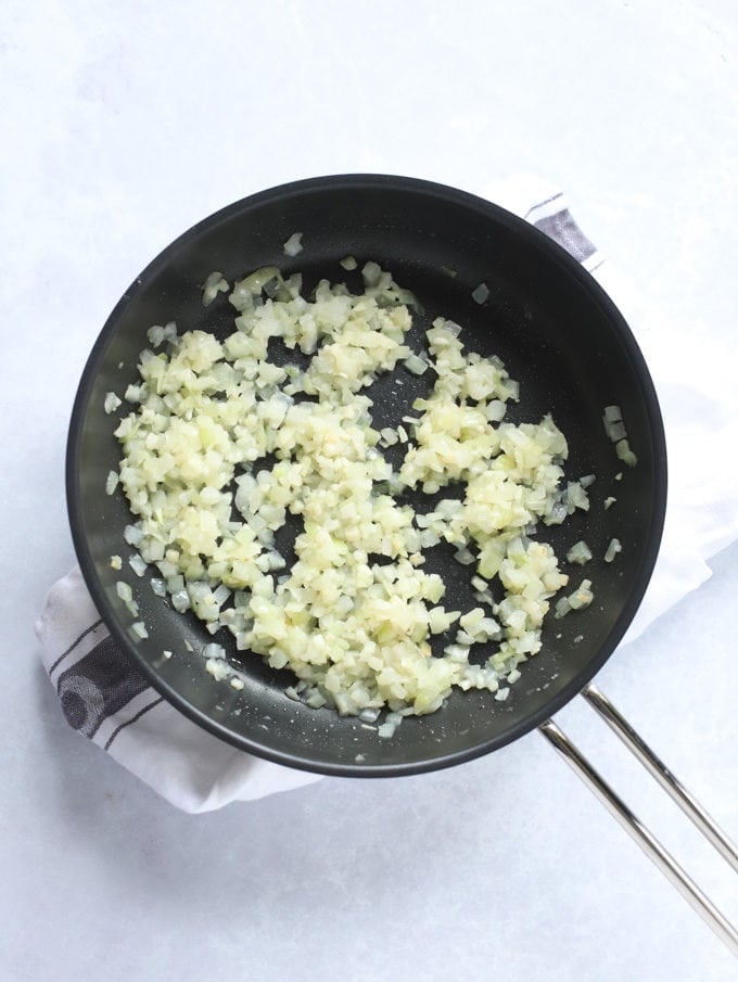 Onions and garlic softening and frying in frying pan for the recipe Sausage Pasta.