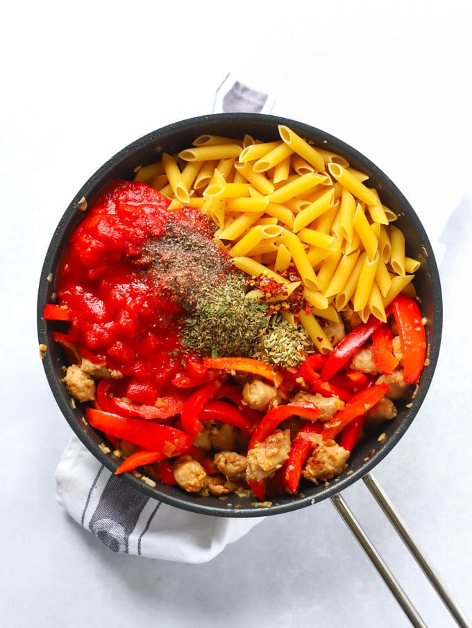 Ingredients for one pot pasta in a frying pan ready to cook for the recipe Sausage Pasta.