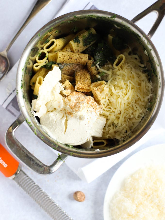 Saucepan with vegetables, and cheese ready to be mixed.