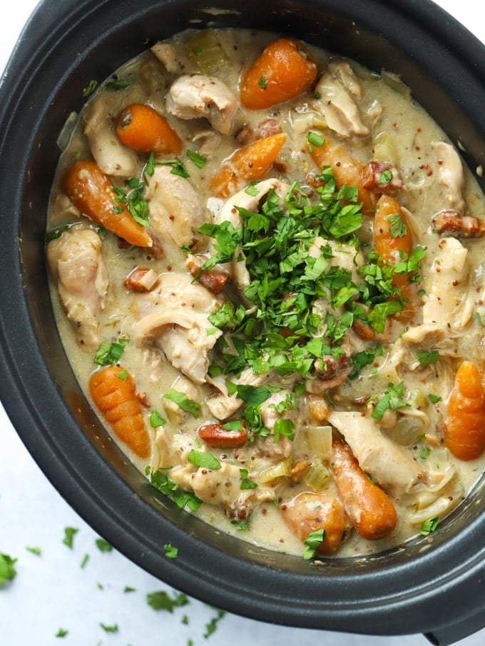 Easy slow cooker chicken casserole with bacon and carrots sprinkled with parsley