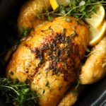 Slow cooker whole roast chicken in a crock pot pan with lemon and herbs
