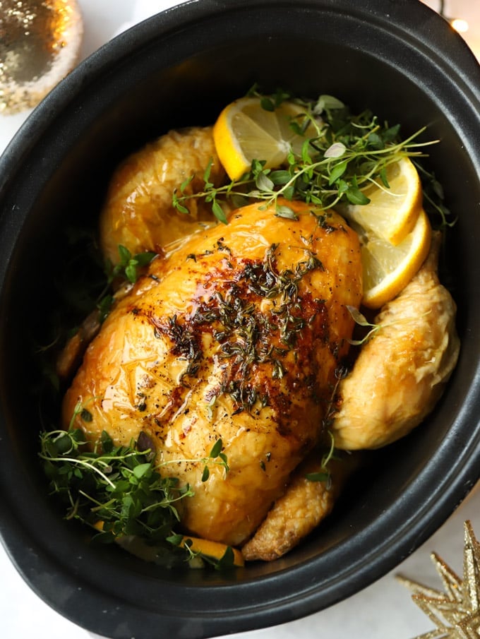 Slow cooker roast chicken with lemon and herbs, cooked and ready to serve.