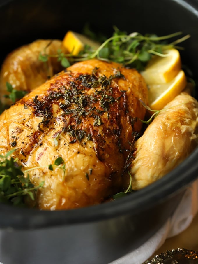 Whole chicken roasted in a slow cooker, ready to eat.