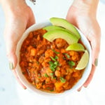 Vegetarian chilli in a bowl with chipotle and butternut squash, avocado and lime