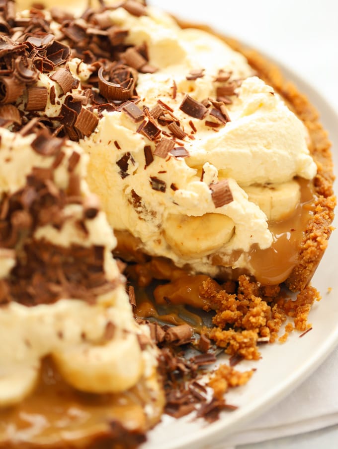 A close up of a delicious homemade Banoffee Pie, sliced and showing the gooey insides.