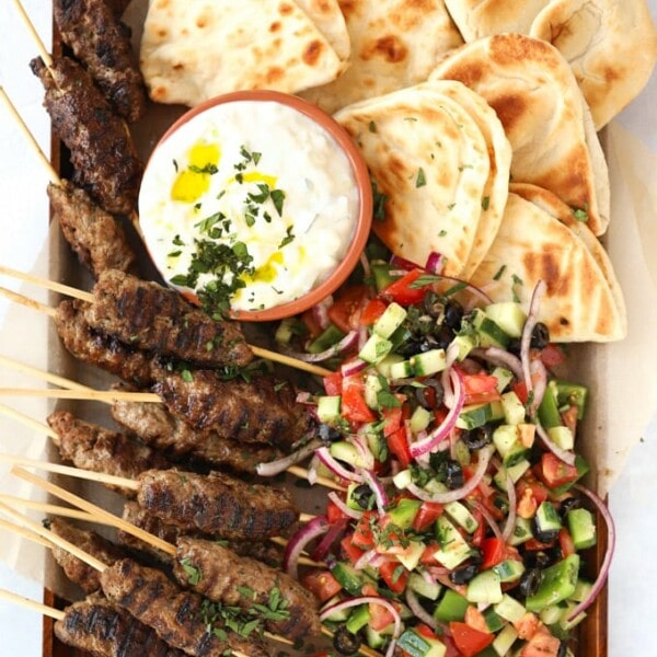 Lamb kofta kebabs recipe with flatbreads and Greek salad and tzatziki.