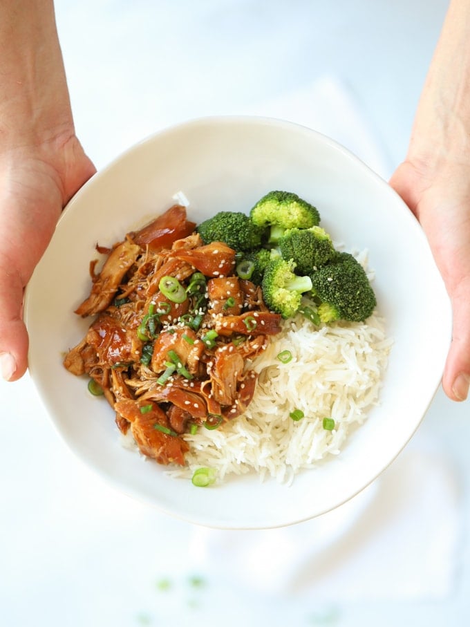 Bowl of sticky asian chicken with broccoli and rice.