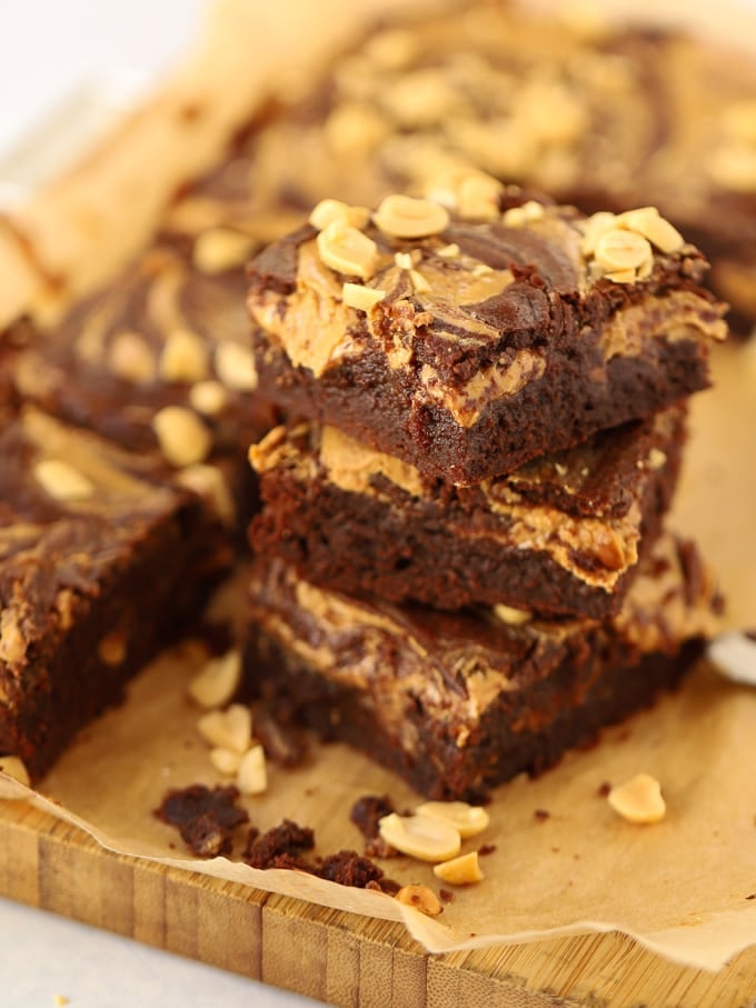 Piled brownie squares topped with peanuts