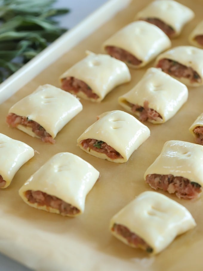 Raw sausage rolls ready to be cooked brushed with beaten egg