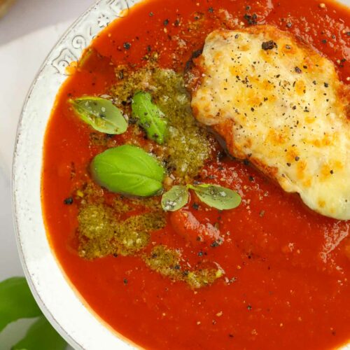 Comfort food for winter - Easy Tomato Soup in a bowl with cheesy toast and pesto.