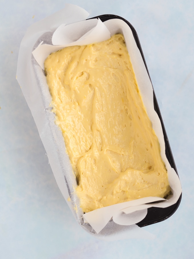 Loaf tin lined with baking paper and filled with cake mixture