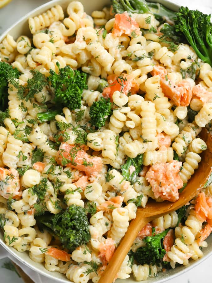 Pan of pasta with smoked salmon, tenderstem broccoli and lemon.