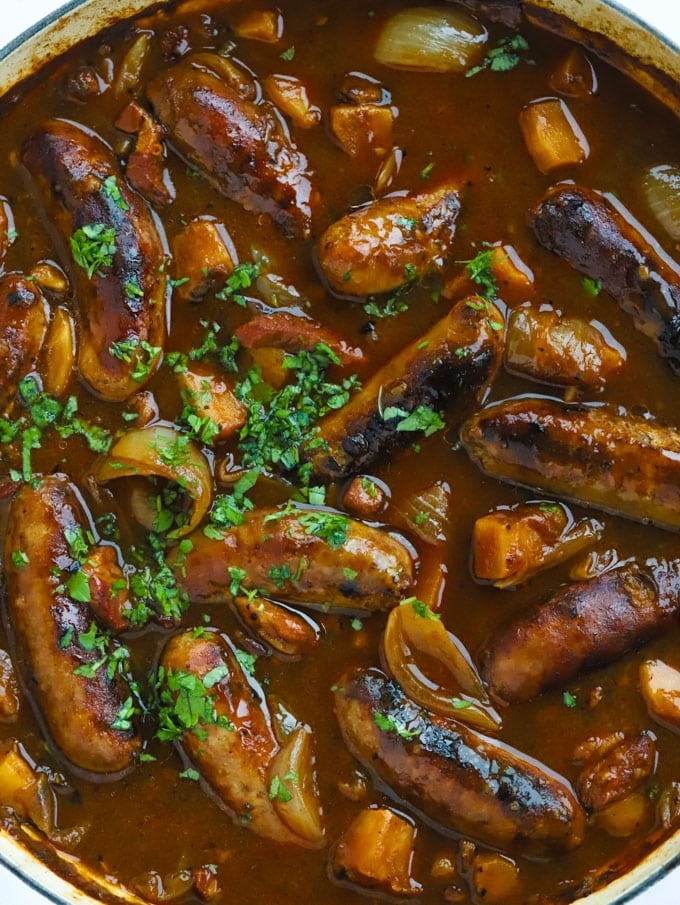 Sausage casserole recipe with apples, cider and bacon sprinkled with herbs