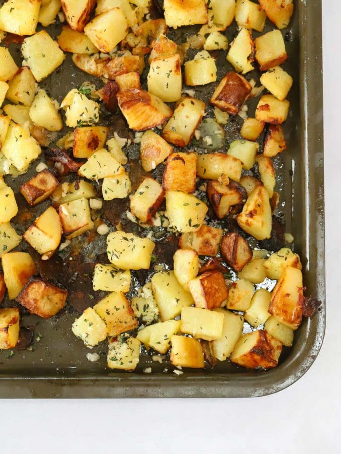 Cooked and golden cubes of potatoes on a baking tray for step 2 in the recipe for parmentier potatoes.