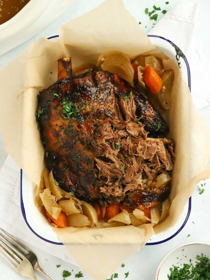 Slow cooker lamb shoulder with mint jelly carrots and onions.