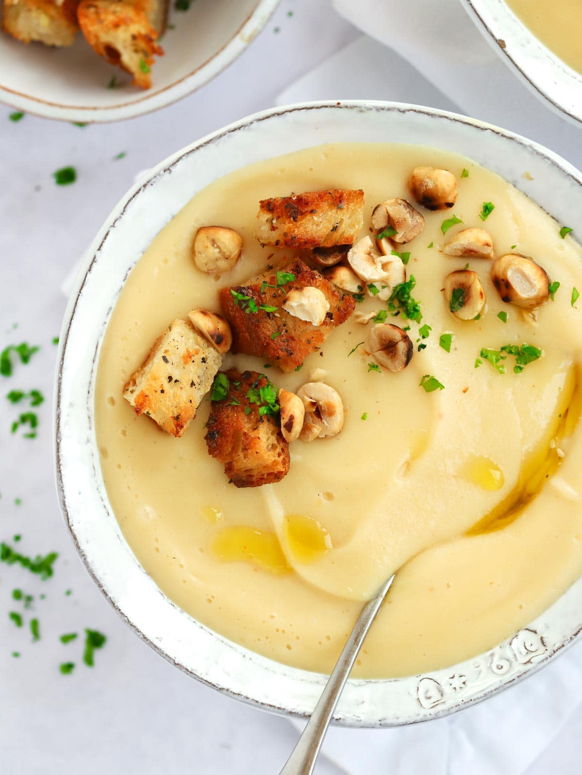 A bowl of Parsnip Soup with Garlic Bread Croutons onto.