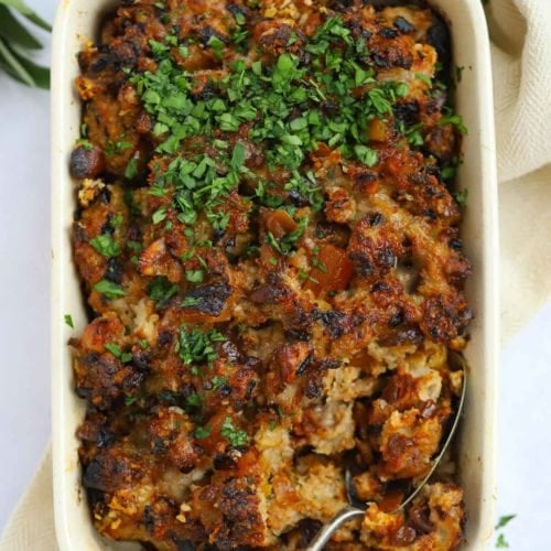 Stuffing recipe in a shallow dish with sausages and apricots for Christmas