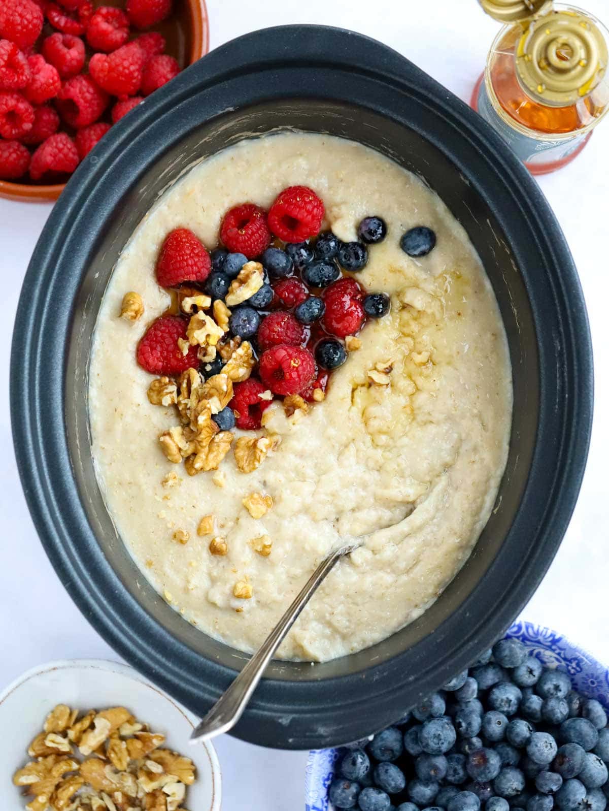 Slow cooker porridge with berries and nuts, ready to serve.