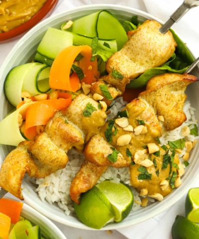 Chicken Satay recipe on a bed of rice and salad