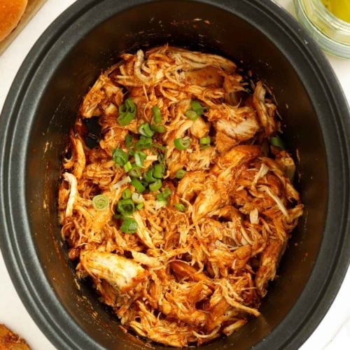 Barbecue Pulled Chicken Slow Cooker Recipe topped with spring onions.