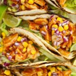Close up of chicken tacos with lettuce and sweetcorn
