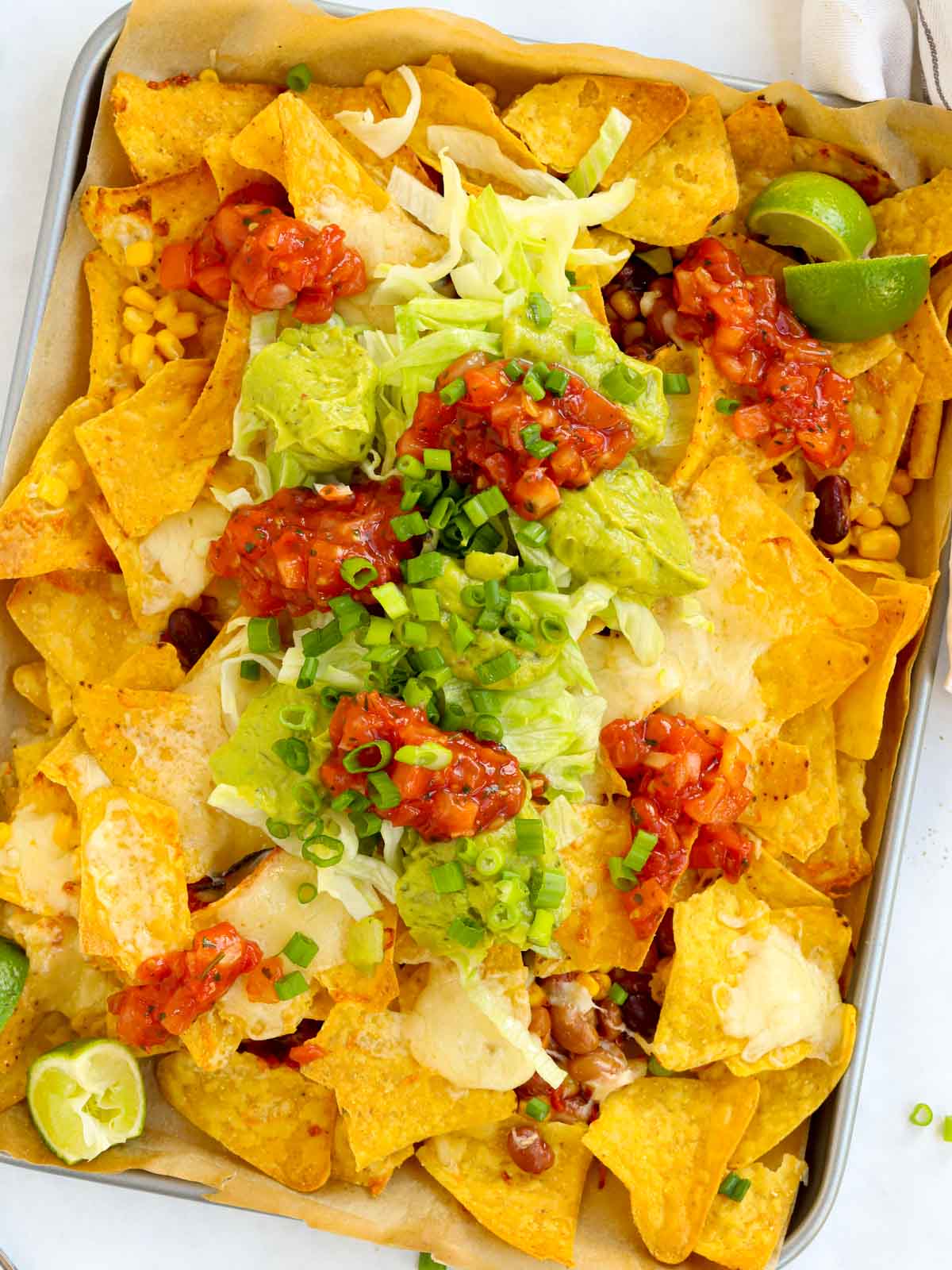 Quick veggie loaded nachos topped with guacamole and salsa