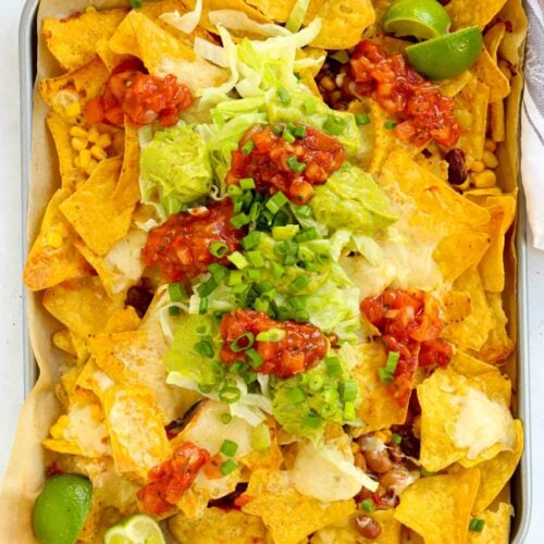 simple loaded nachos with sweetcorn and beans, topped with cheese, guacamole and salsa
