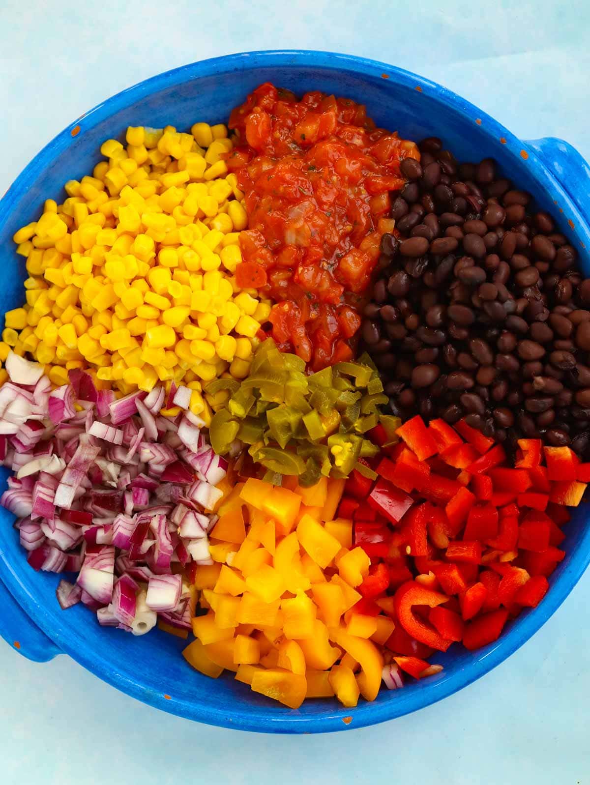 Ingredients of a Mexican Salad - A colourful rainbow effect in a bowl.