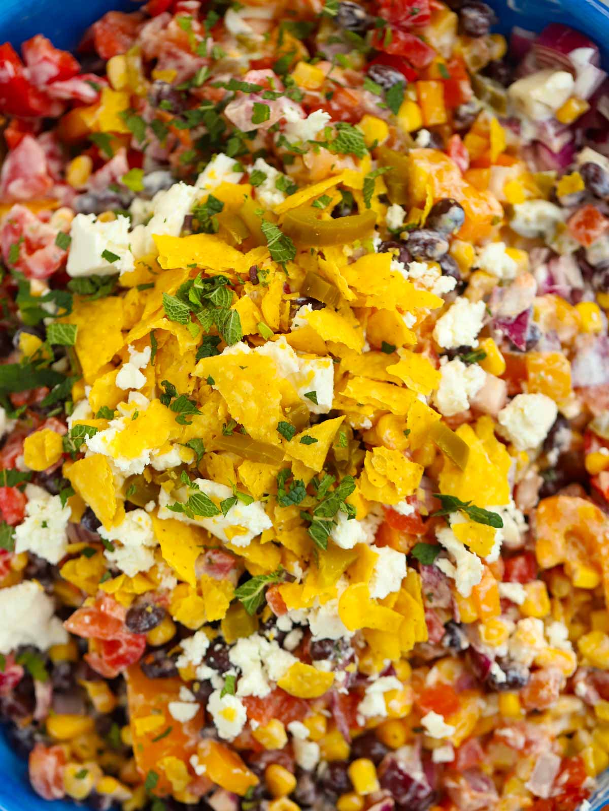 A close up of Mexican Salad ingredients in a bowl, mixed together. 