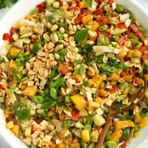 Salad with peanuts, mango, cabbage, peppers and cucumber