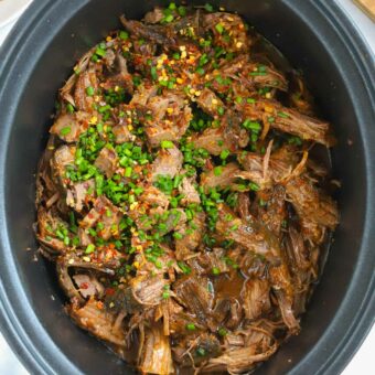 Beef brisket finished in a slow cooker ready to be served.