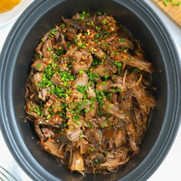 Beef brisket slow cooked in a slow cooker.