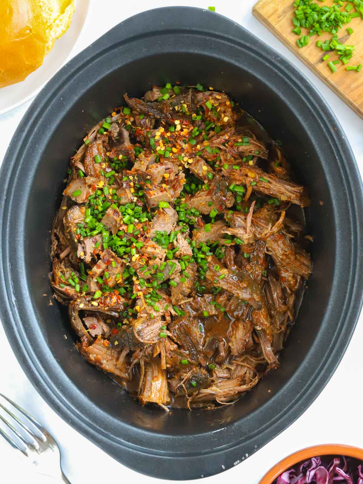Beef brisket slow cooked in a slow cooker.