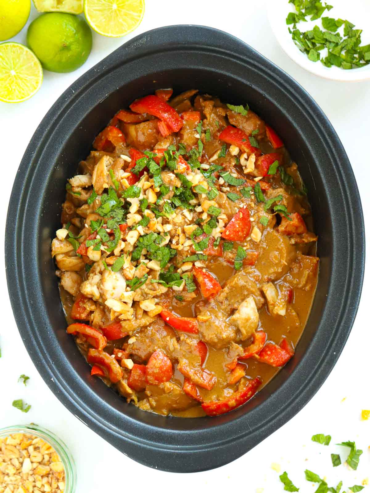 Pan filled with cooked Slow Cooker Chicken Satay.