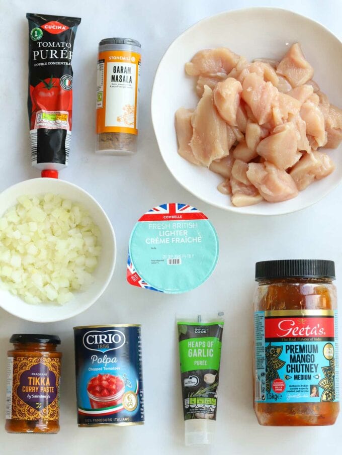The ingredients layed out in their packets, showing what you need for the a slow cooker chicken tikka masala recipe.