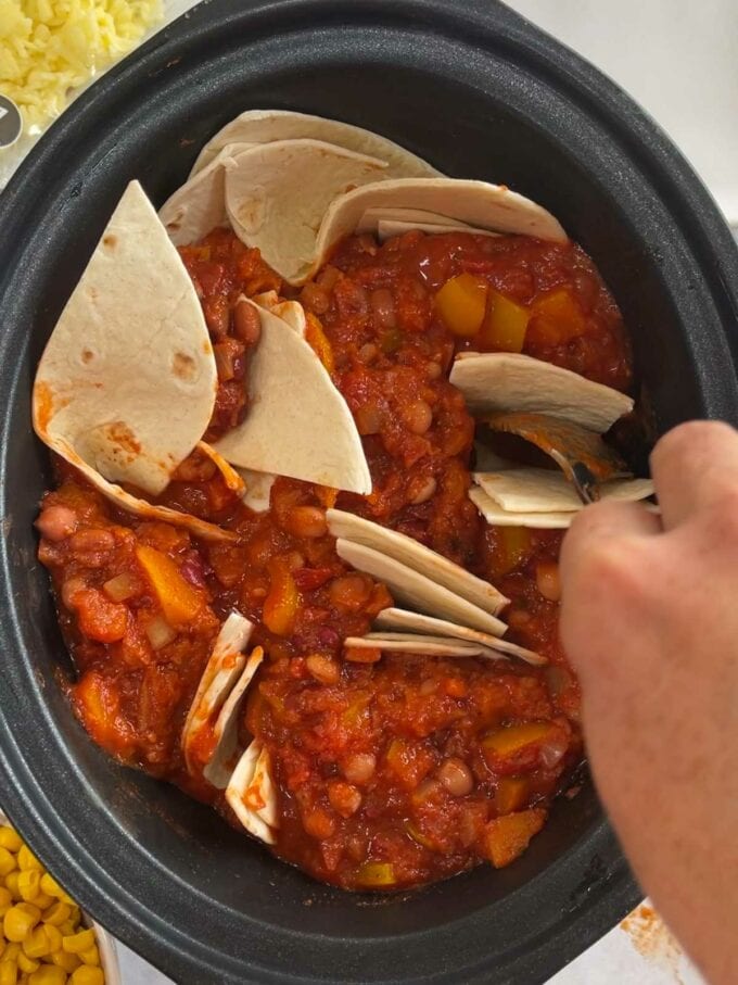 Step two in the instructions of how to make veggie enchiladas in the slow cooker.