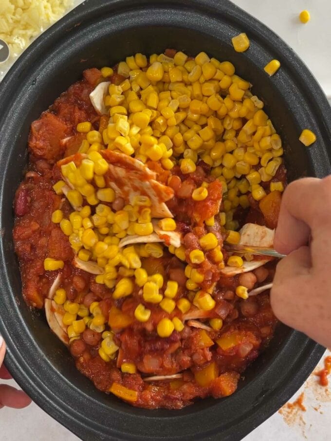 Step 2 in the instructions of how to make veggie enchiladas in the slow cooker.