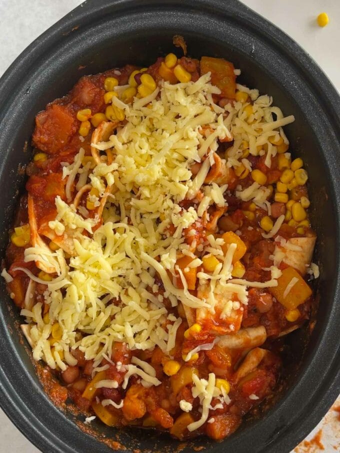 Step 4 in the instructions of how to make veggie enchiladas in the slow cooker.